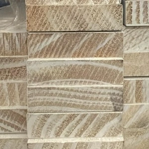 Stack of prime coated pine timber dressed all around architraves or skirting boards, which is a type of moulding installed around door frames