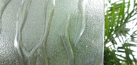Large textured glass against palm trees